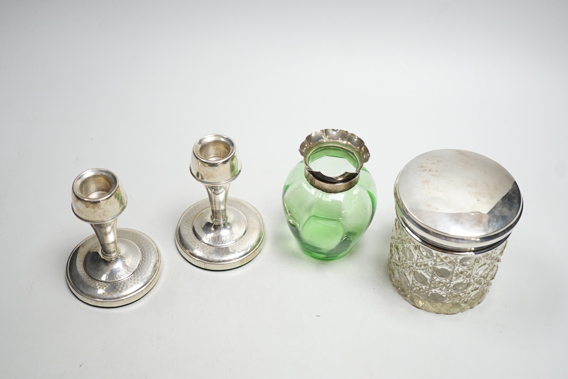 A pair of mid 20th century silver mounted dwarf candlesticks, 92mm, a silver mounted glass jar and a green glass vase.